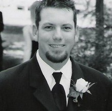 A black and white photo of John Murray in a suit.