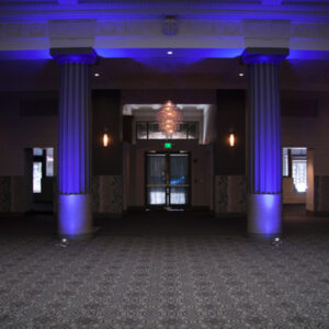 A large room with blue lighting and pillars.