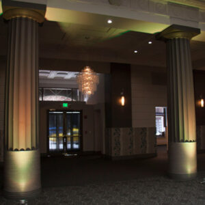 A hallway with pillars and lighting.