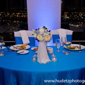 A blue table setting with a view of the city.