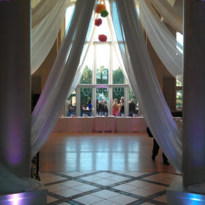 A room with pillars and drapes.