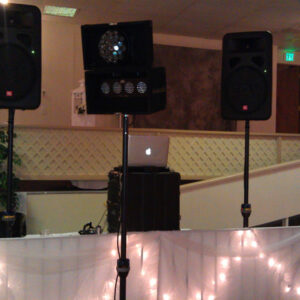 Dj equipment on a table in a room.