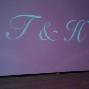A projection screen with the letter t and h on it.