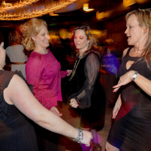 A group of women dancing at a party.