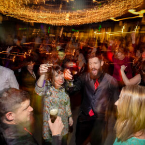 A group of people dancing at a party.