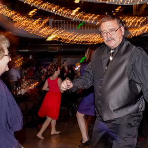 A man and woman dancing at a wedding reception.
