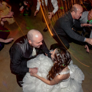 A bride and groom dancing on the dance floor.
