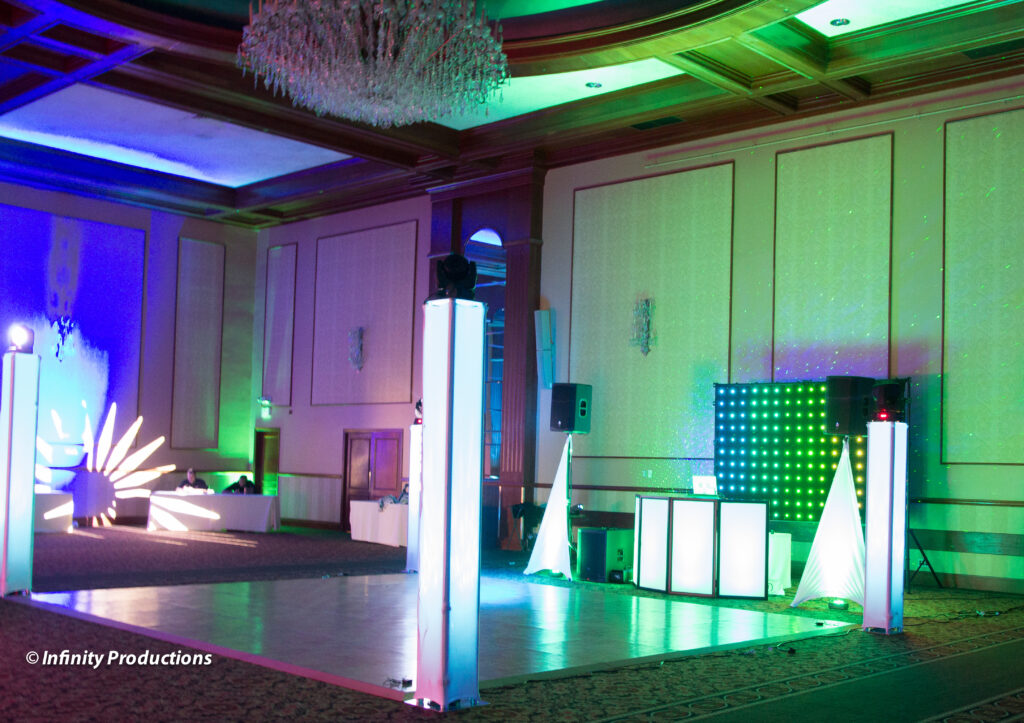 A large ballroom with a stage and lights.