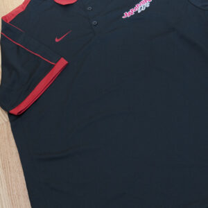 A black and red Nike apparel on a wooden floor.