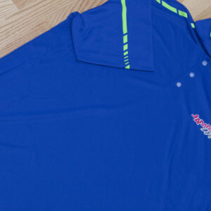 A men's blue polo shirt on a hardwood floor.