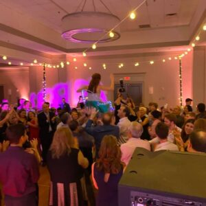 People dancing at a wedding reception, with pictures.