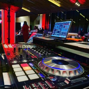 A DJ set up for a Bat Mitzvah in a room.