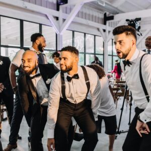 A group of people dancing at a wedding reception.