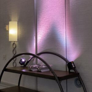 A shelf with a lamp on it next to a wall.