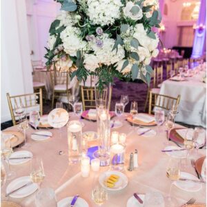A table setting with white flowers and silverware.