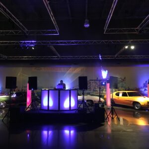 The SIMCHA company brought their entertainment expertise to a museum, setting up a DJ booth with cars in the background.