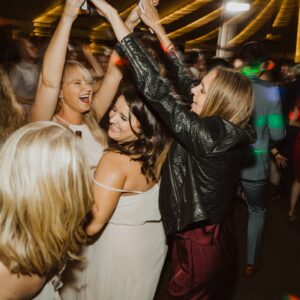 A group of bridesmaids dancing at a party.