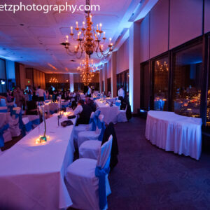 A wedding reception with blue and white tables and chairs, featuring a DJ Equipment setup for an unforgettable night of music and dancing.
