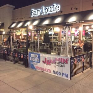 A lively restaurant with a sign that says barjoie, offering jammin live games and trivia.