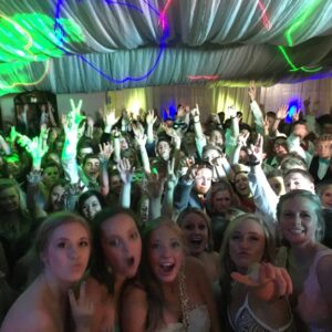 An overview of a large group of people at a school dance party.