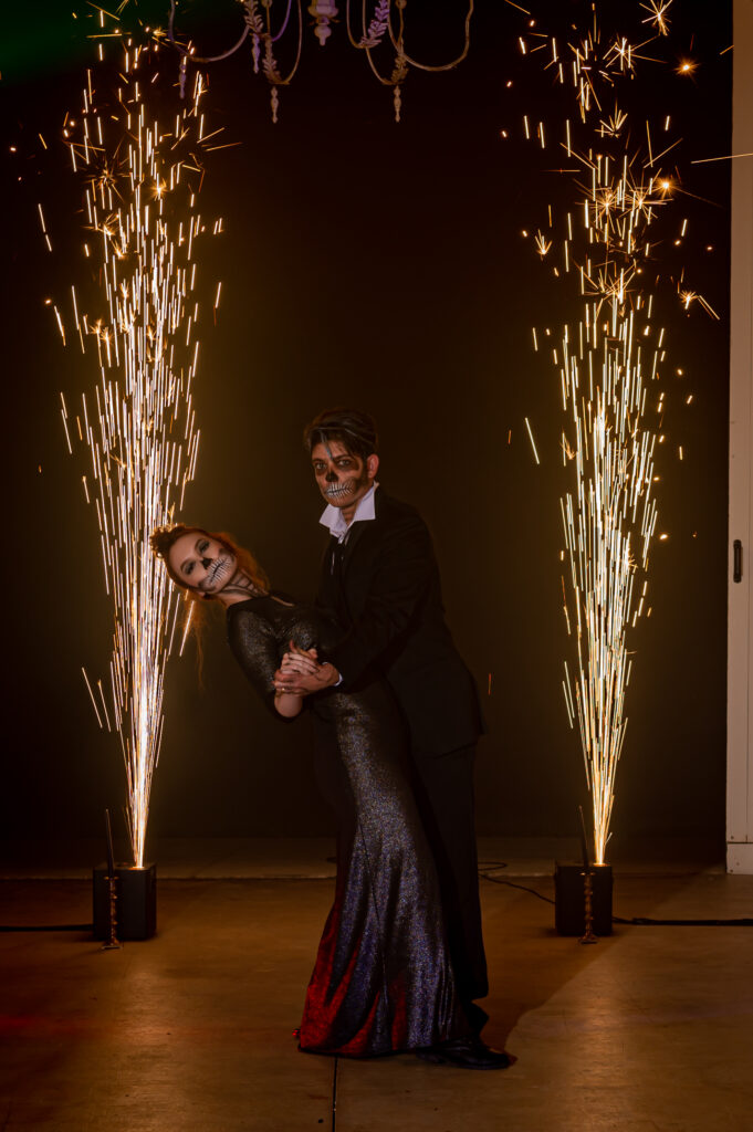 A man and woman dancing in front of sparklers at a bat mitzvah.
