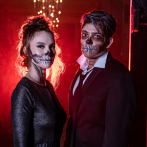A man and woman with face paint at a bar mitzvah.