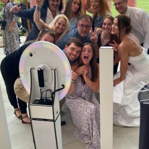 A group of people posing in front of a photo booth rental.