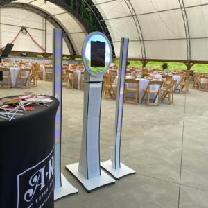 A large tent with tables and chairs in it, set up for a bar mitzvah.