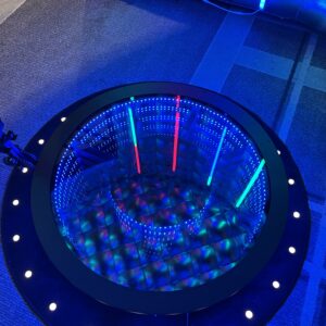 A circular table with blue lights on it, prepared for a bar mitzvah.