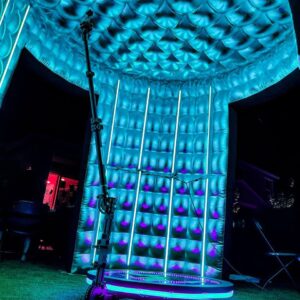 A room with a blue light in the middle of it, hosting a bar mitzvah.
