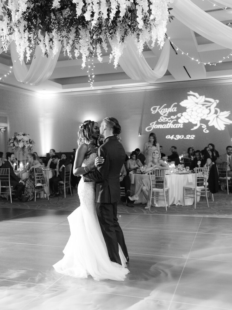 A bride and groom sharing their first dance at a wedding reception, as the Denver DJ plays their favorite song.