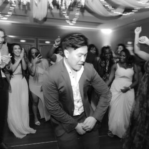 A man dancing on the dance floor at a bar mitzvah.