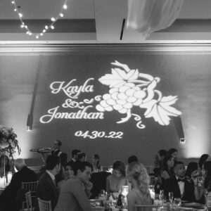 A black and white photo of a wedding reception featuring a wedding DJ.