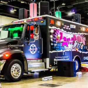 A wedding DJ truck is parked inside a building.