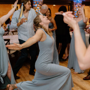 A group of bridesmaids dancing at a wedding reception, entertained by a Denver DJ service.