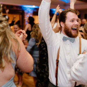 A man is dancing on the dance floor at a wedding reception, entertained by a Denver DJ.