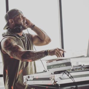 A Denver DJ playing music in front of a laptop at a bar mitzvah.
