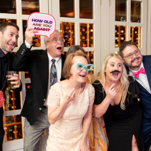 A group of people posing for a photo booth rental.
