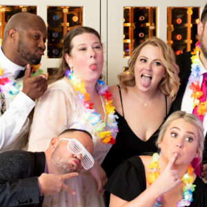 A group of people posing for a photo at a wedding.