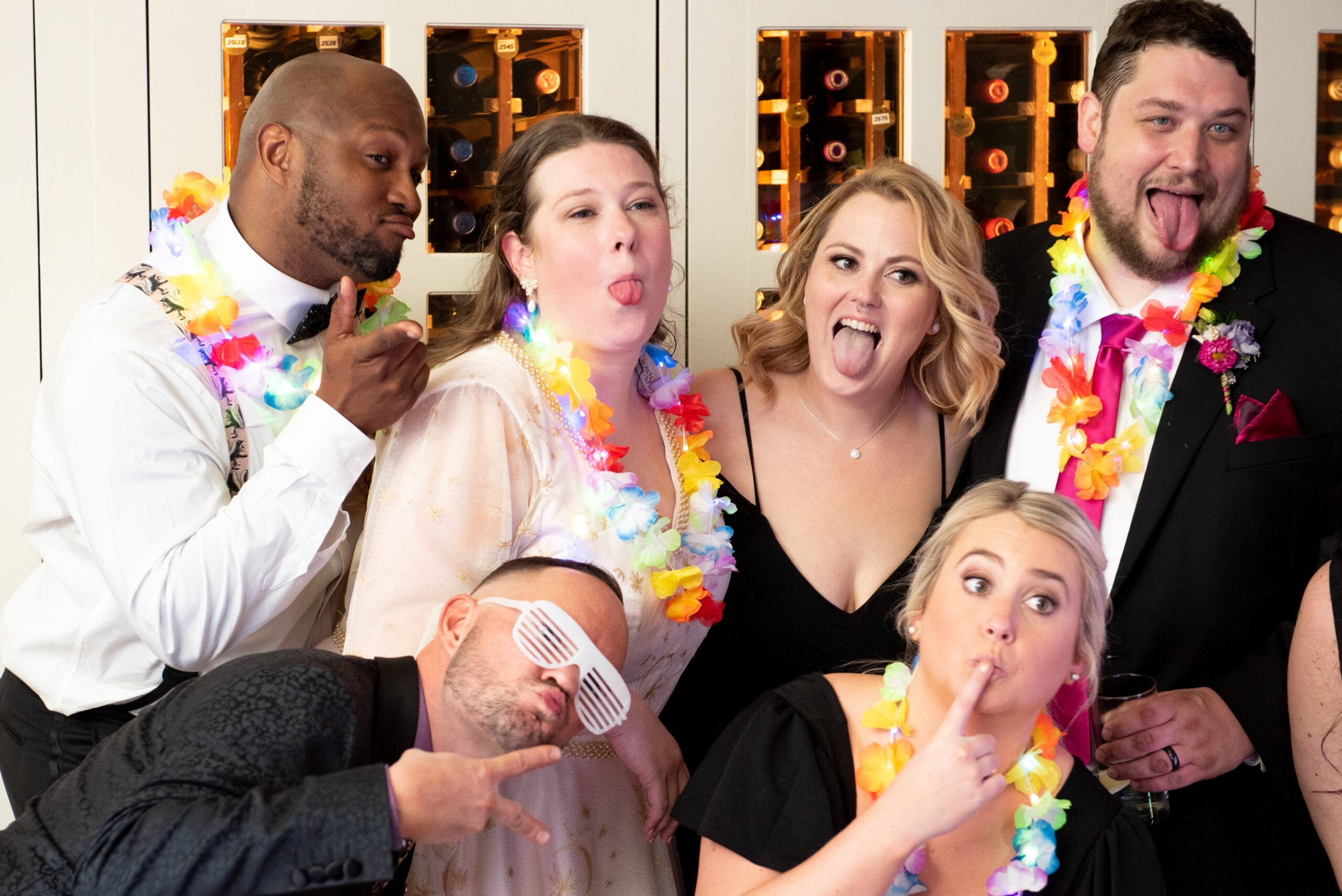 A group of people posing for a photo at a wedding.