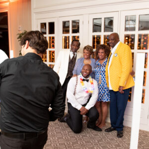 A group of people posing in front of a Denver DJ photo booth rental.