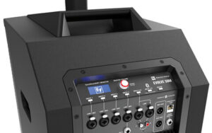 Close-up of a black portable DJ equipment sound mixer with multiple knobs, buttons, and a digital display, labeled "evolve 50m".
