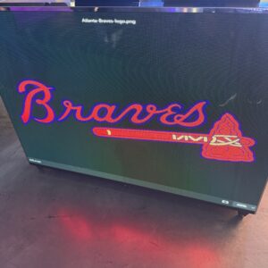 A television screen displaying the Atlanta Braves logo with the word "Braves" and an image of a tomahawk underneath.