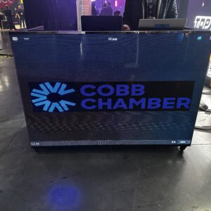 LED screen displaying "Cobb Chamber" logo at an indoor event.